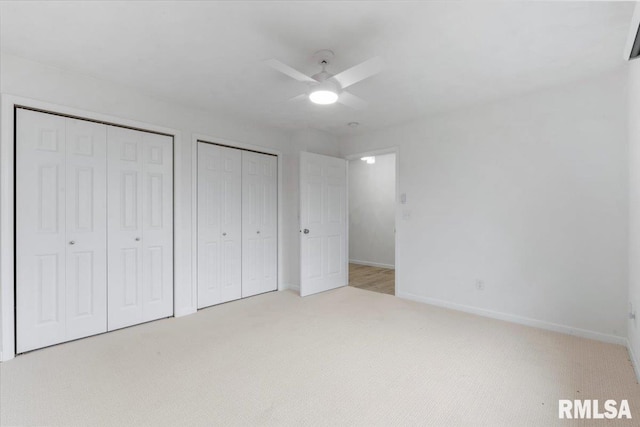 19109 Bluff Rd Unit D, Geneseo, IL 61254 - unfurnished bedroom featuring multiple closets, carpet, and a ceiling fan