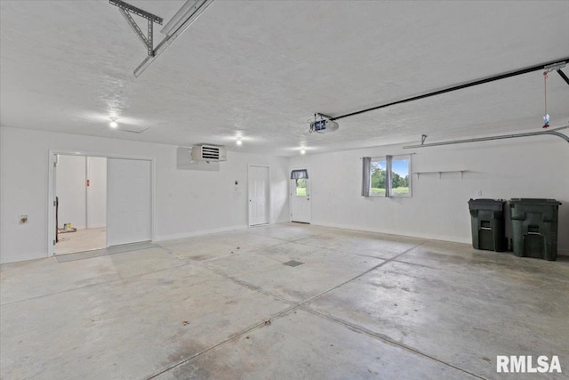 19109 Bluff Rd Unit D, Geneseo, IL 61254 - garage featuring a garage door opener and baseboards
