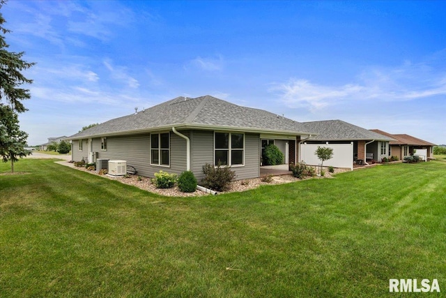 19109 Bluff Rd Unit D, Geneseo, IL 61254 - back of property with a yard and roof with shingles
