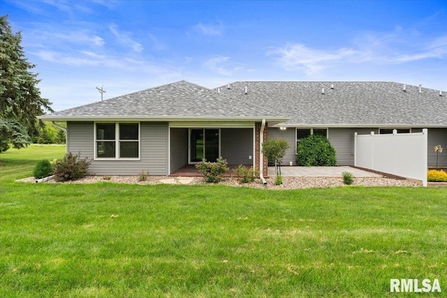 19109 Bluff Rd Unit D, Geneseo, IL 61254 - back of property with a patio, a lawn, and roof with shingles