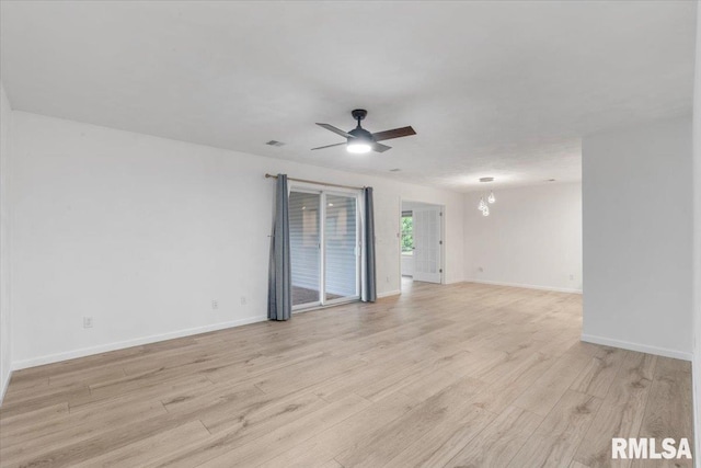 19109 Bluff Rd Unit D, Geneseo, IL 61254 - unfurnished room with light wood-style floors, ceiling fan, and a chandelier