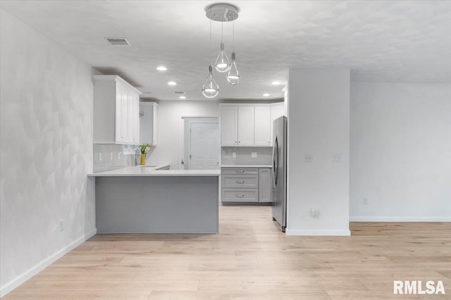 19109 Bluff Rd Unit D, Geneseo, IL 61254 - kitchen featuring freestanding refrigerator, a peninsula, light wood-type flooring, light countertops, and recessed lighting