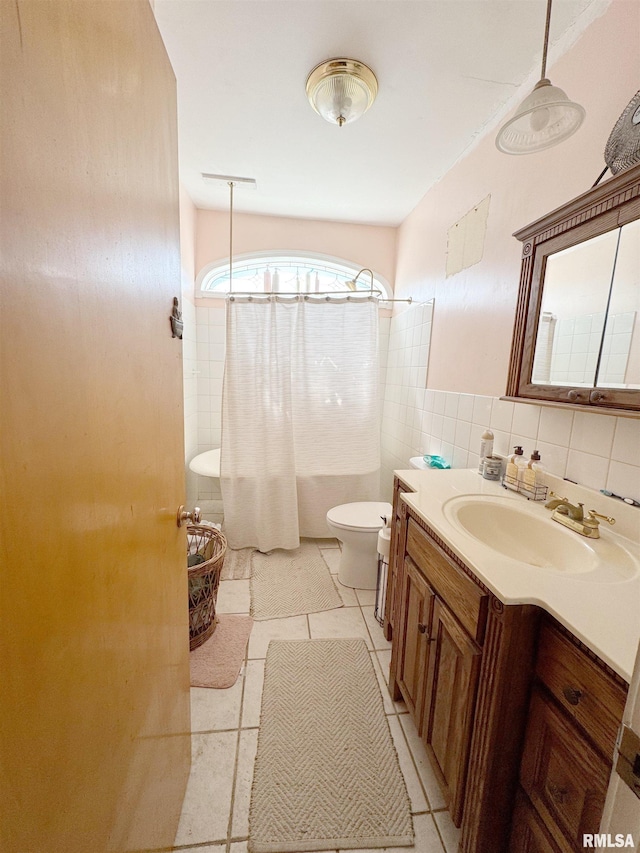 1001 S 14th St, Herrin, IL 62948 - full bath featuring toilet, vanity, shower / tub combo, and tile walls