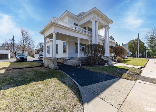 1440 12th St, Moline, IL 61265 - greek revival house featuring a balcony, a porch, and a front lawn