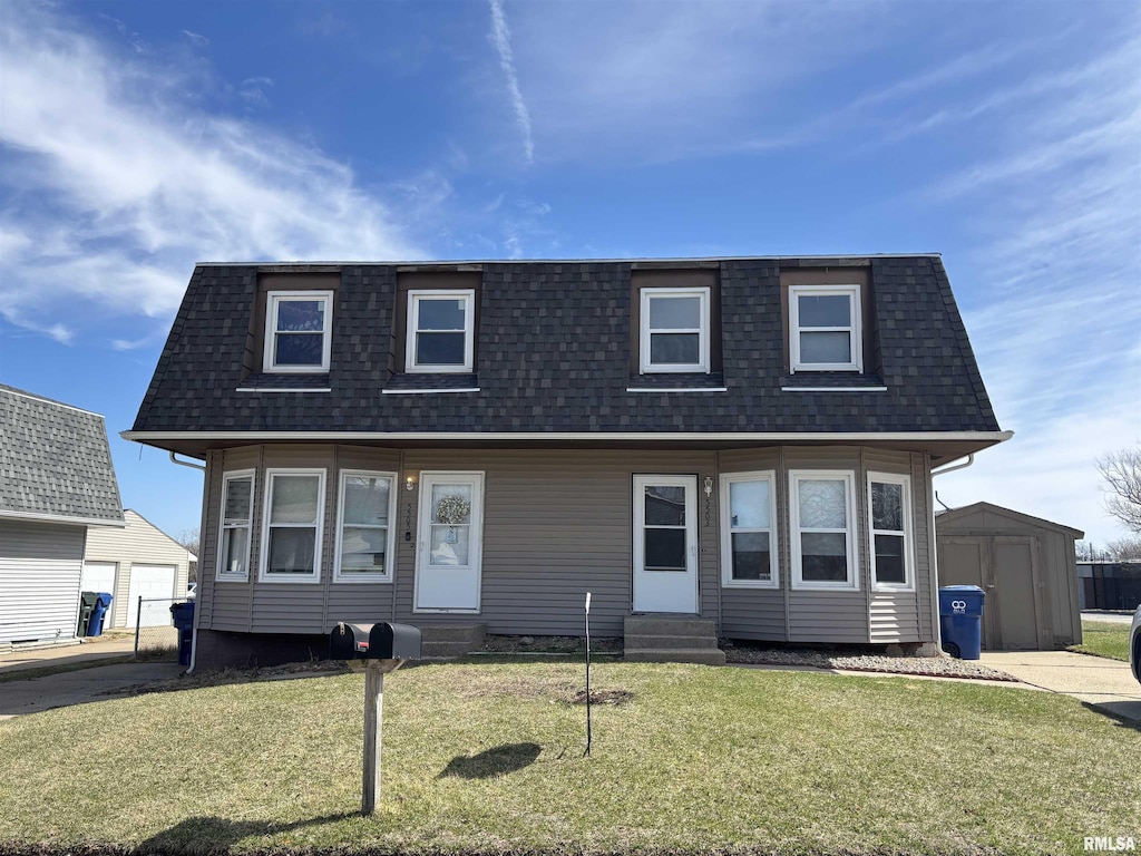 view of front of house with an outbuilding, a shingled roof, mansard roof, and entry steps