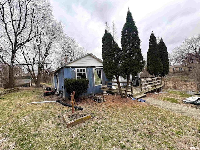 502 E 2nd St, Maquon, IL 61458 - exterior space featuring an outdoor structure, a front yard, and a deck