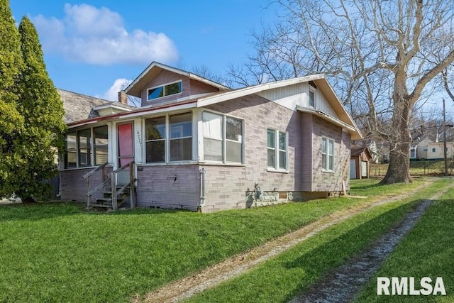 4227 11th St, Rock Island, IL 61201 - view of home's exterior with entry steps and a yard
