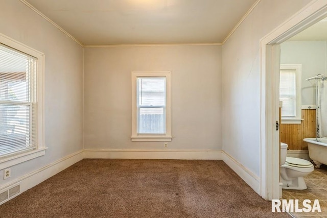4227 11th St, Rock Island, IL 61201 - spare room with baseboards, carpet floors, ornamental molding, and visible vents