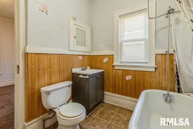 4227 11th St, Rock Island, IL 61201 - full bath with wooden walls, toilet, a freestanding tub, vanity, and wainscoting