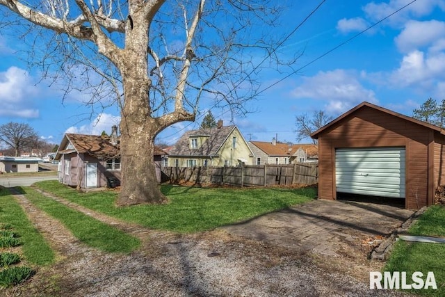 4227 11th St, Rock Island, IL 61201 - view of yard with driveway, an outdoor structure, fence, a residential view, and a garage
