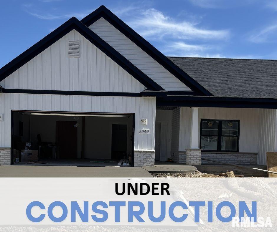 3949 Meadowlark Ct, Bettendorf, IA 52722 - view of front of house featuring a garage and brick siding