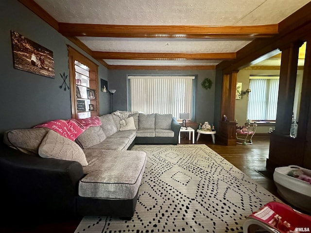 121 E Church St, Galatia, IL 62935 - living room featuring a textured ceiling, beamed ceiling, and wood finished floors