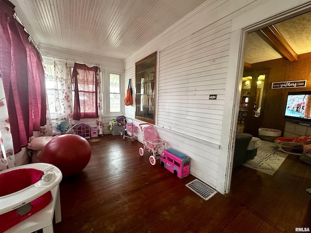 121 E Church St, Galatia, IL 62935 - living area with wood finished floors, crown molding, wood walls, and visible vents