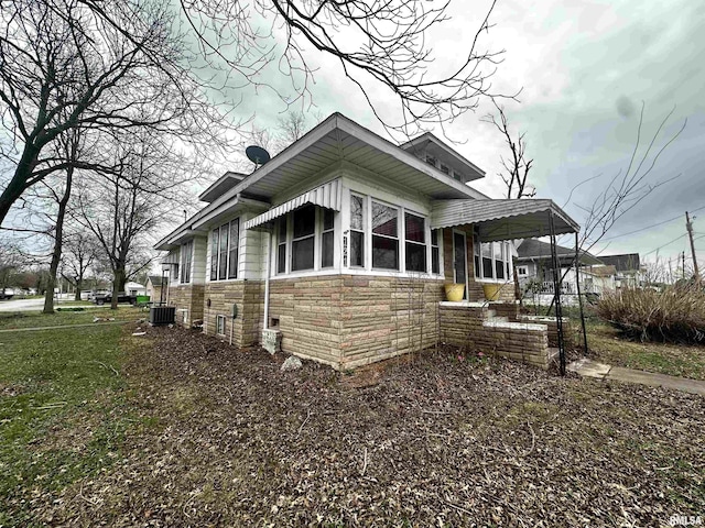 121 E Church St, Galatia, IL 62935 - view of home's exterior with stone siding and central AC