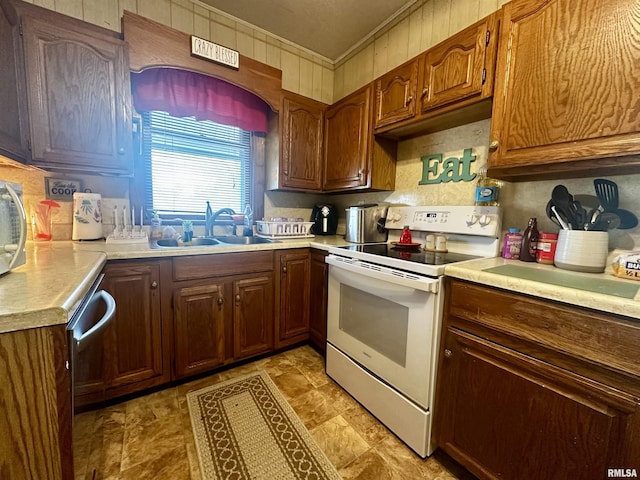 121 E Church St, Galatia, IL 62935 - kitchen featuring light countertops, crown molding, brown cabinets, a sink, and white range with electric cooktop