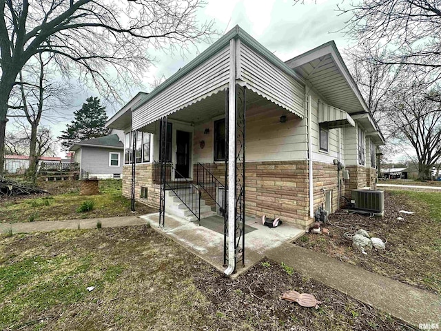 121 E Church St, Galatia, IL 62935 - view of front of home featuring cooling unit and stone siding