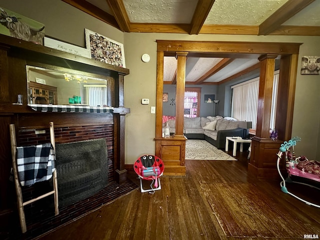 121 E Church St, Galatia, IL 62935 - living area featuring hardwood / wood-style floors, a fireplace, and vaulted ceiling with beams