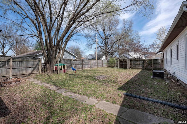 view of yard featuring cooling unit, an outdoor structure, and a fenced backyard
