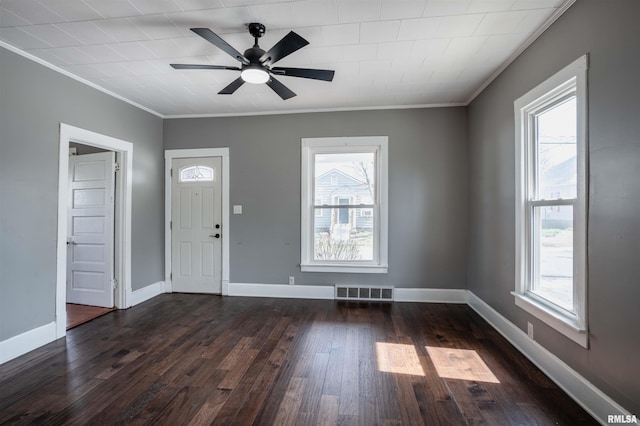 foyer entrance with a wealth of natural light, visible vents, and dark wood-style floors