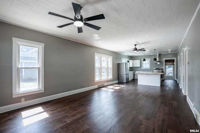 unfurnished living room featuring a ceiling fan, dark wood-style flooring, baseboards, and visible vents