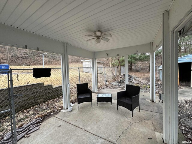 view of patio / terrace with fence and a ceiling fan