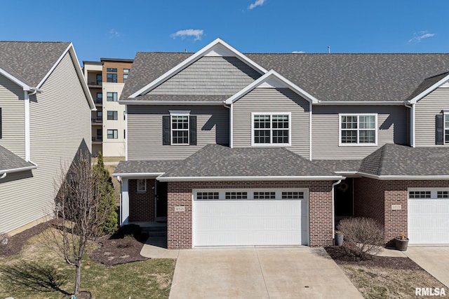 4521 Slate Creek Dr, Bettendorf, IA 52722 - view of property featuring concrete driveway, brick siding, and roof with shingles
