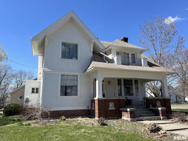 100 S Franklin St, Clayton, IL 62324 - view of front of house with a balcony, a chimney, brick siding, a shingled roof, and a porch