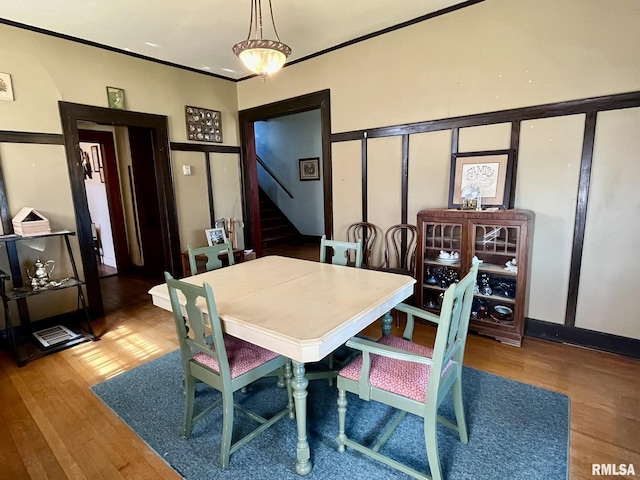 100 S Franklin St, Clayton, IL 62324 - dining area with ornamental molding, wood finished floors, and stairway