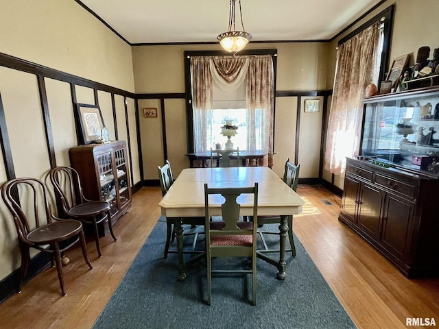100 S Franklin St, Clayton, IL 62324 - dining room featuring baseboards, crown molding, and light wood-style floors