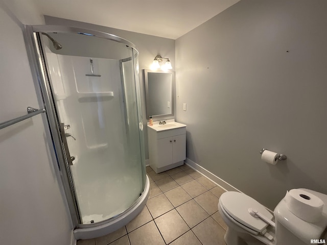 bathroom with a stall shower, tile patterned floors, toilet, vanity, and baseboards