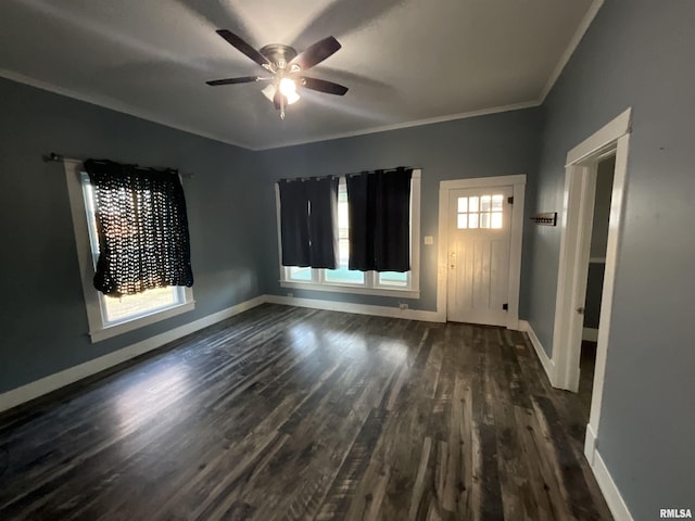 interior space with crown molding, dark wood-style floors, baseboards, and ceiling fan