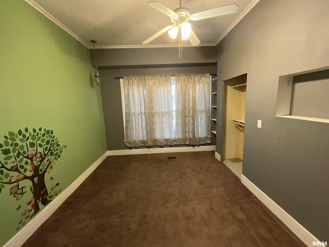 carpeted spare room with baseboards, ceiling fan, and ornamental molding