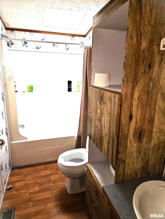 full bathroom with wood finished floors, toilet, and vanity