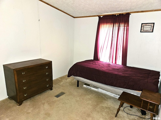 carpeted bedroom featuring ornamental molding and a textured ceiling