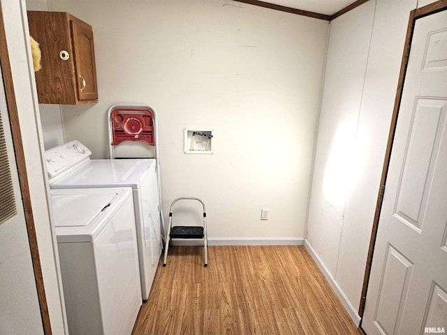 laundry area featuring cabinet space, light wood-style floors, separate washer and dryer, a heating unit, and baseboards
