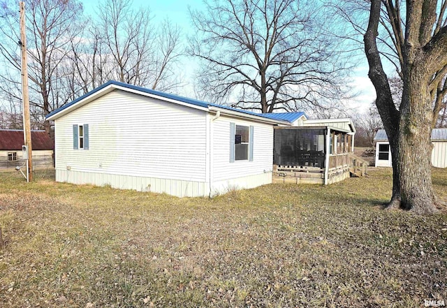 view of property exterior with a sunroom