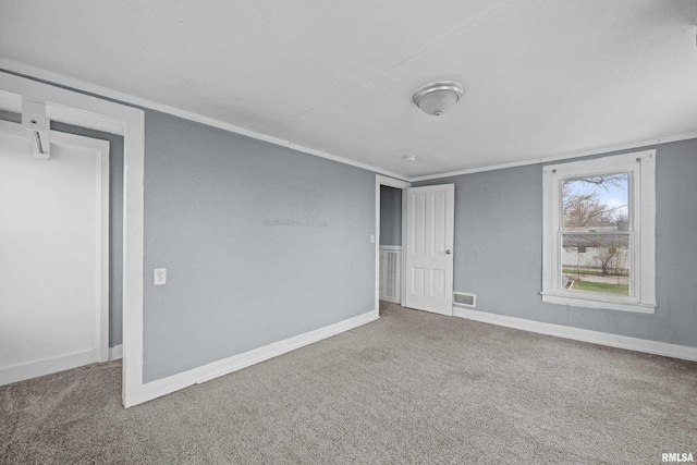 unfurnished room with visible vents, baseboards, and carpet