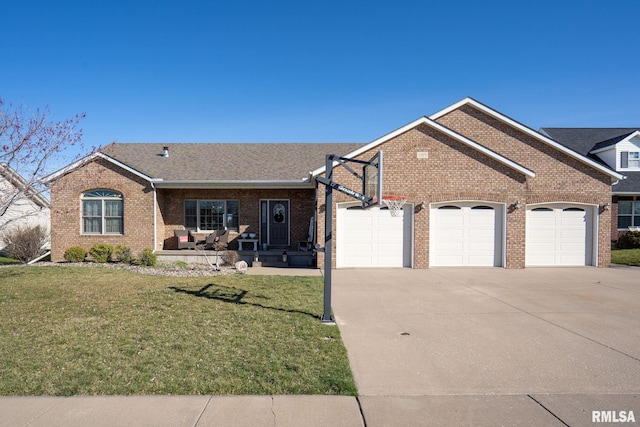 922 W Scott St, Eldridge, IA 52748 - single story home with driveway, brick siding, a garage, and a front yard