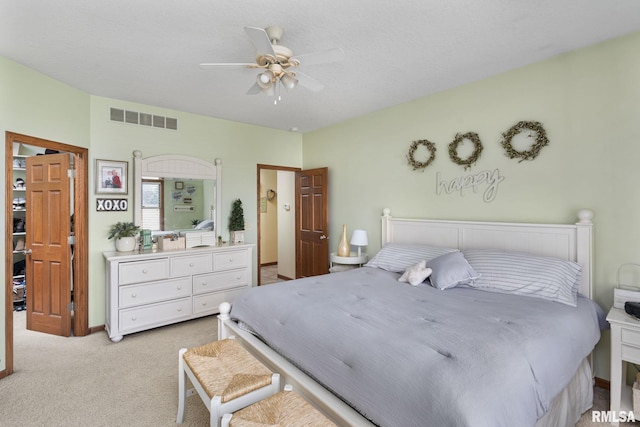 922 W Scott St, Eldridge, IA 52748 - bedroom featuring ceiling fan, visible vents, and light carpet