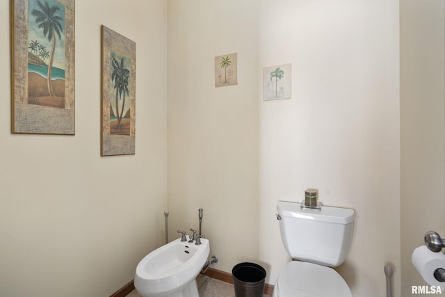922 W Scott St, Eldridge, IA 52748 - bathroom with toilet, baseboards, and a bidet