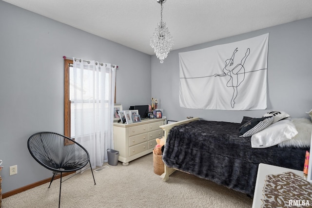 922 W Scott St, Eldridge, IA 52748 - bedroom with baseboards, visible vents, a notable chandelier, and light carpet