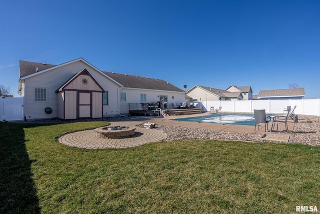 922 W Scott St, Eldridge, IA 52748 - back of property featuring a fenced backyard, a lawn, an outdoor structure, and a fenced in pool