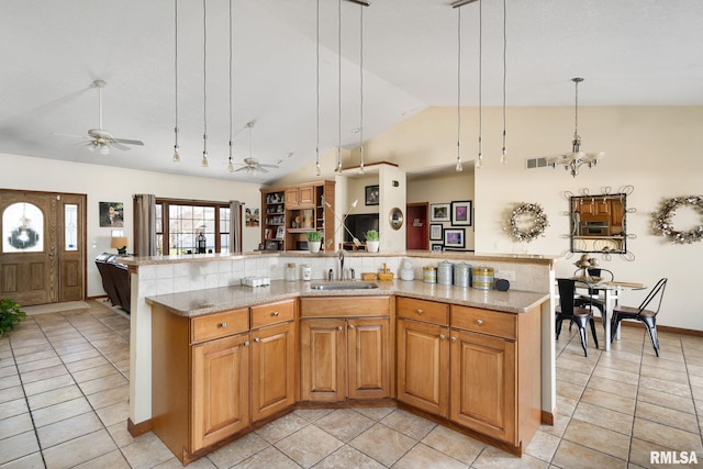 922 W Scott St, Eldridge, IA 52748 - kitchen featuring open floor plan, ceiling fan with notable chandelier, a spacious island, backsplash, and a sink