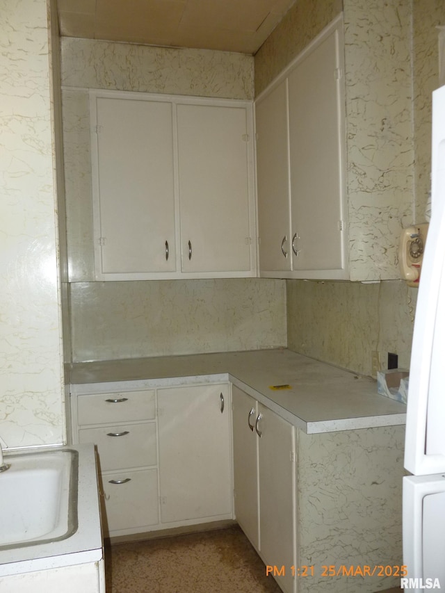 145 6th Ave, Moline, IL 61265 - kitchen featuring light countertops, a sink, and white cabinets