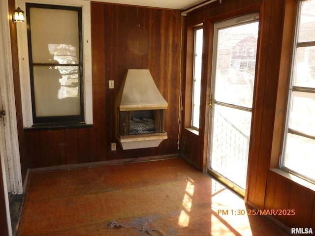 145 6th Ave, Moline, IL 61265 - unfurnished living room featuring wood walls and plenty of natural light