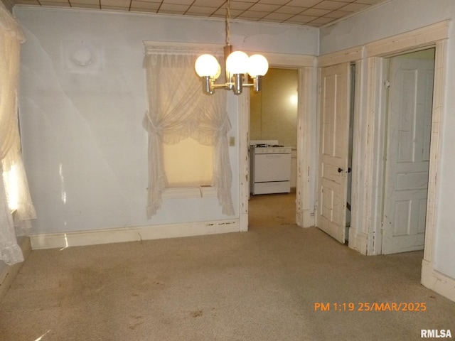 145 6th Ave, Moline, IL 61265 - unfurnished dining area featuring carpet flooring, a chandelier, and baseboards