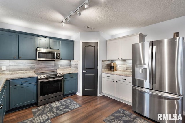 1708 Westport Dr, Davenport, IA 52804 - kitchen featuring decorative backsplash, a textured ceiling, visible vents, track lighting, and stainless steel appliances