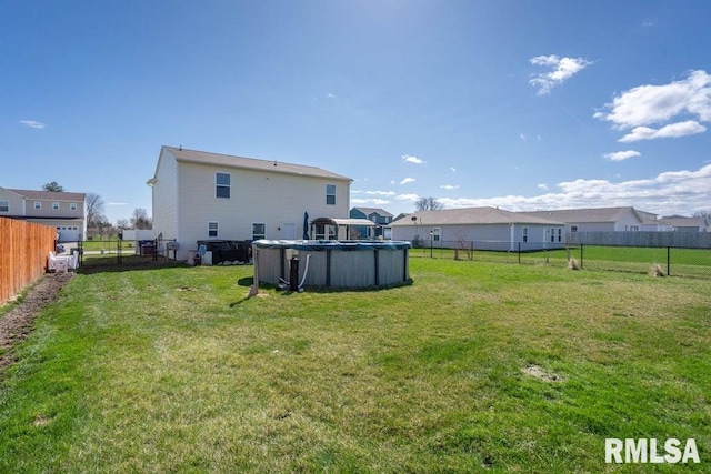 1708 Westport Dr, Davenport, IA 52804 - back of property with a fenced in pool, a fenced backyard, and a yard