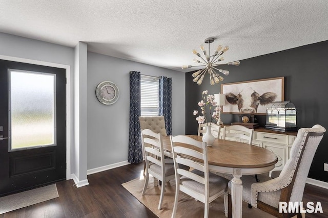 1708 Westport Dr, Davenport, IA 52804 - dining space with a textured ceiling, a chandelier, dark wood-style floors, and baseboards