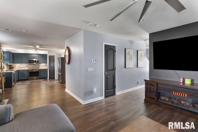 1708 Westport Dr, Davenport, IA 52804 - living room with dark wood-style flooring, ceiling fan, visible vents, and baseboards